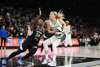 Jun 13, 2025; Las Vegas, Nevada, USA; Las Vegas Aces guard Jewell Loyd (24) collides wth Dallas Wings guard Paige Bueckers (5) in the fourth quarter of their game at Michelob Ultra Arena. Mandatory Credit: Candice Ward-Imagn Images