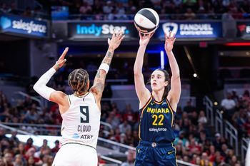 Jun 14, 2025; Indianapolis, Indiana, USA; Indiana Fever guard Caitlin Clark (22) shoots the ball while New York Liberty guard Natasha Cloud (9) defends in the first half at Gainbridge Fieldhouse. Mandatory Credit: Trevor Ruszkowski-Imagn Images