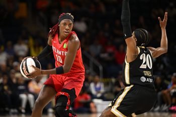 Jun 15, 2025; Washington, District of Columbia, USA; Atlanta Dream guard Rhyne Howard (10) looks to pass in front of Washington Mystics guard Brittney Sykes (20) during the first quarter at CareFirst Arena. Mandatory Credit: Rafael Suanes-Imagn Images