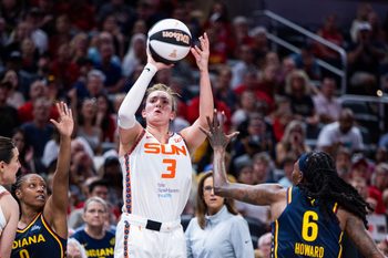 Jun 17, 2025; Indianapolis, Indiana, USA; Connecticut Sun guard Marina Mabrey (3) shoots the ball while Indiana Fever forward Natasha Howard (6) defends in the second half at Gainbridge Fieldhouse. Mandatory Credit: Trevor Ruszkowski-Imagn Images