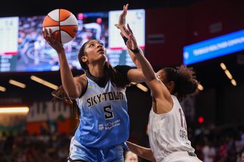 Jun 22, 2025; College Park, Georgia, USA; Chicago Sky forward Angel Reese (5) shoots past Atlanta Dream forward Nia Coffey (12) in the first quarter at Gateway Center Arena at College Park. Mandatory Credit: Brett Davis-Imagn Images