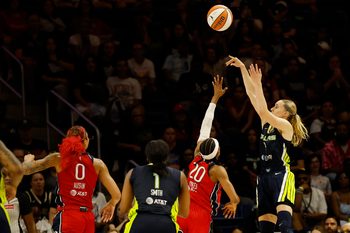 Jun 22, 2025; Washington, District of Columbia, USA; Dallas Wings guard Paige Bueckers (5) shoots the ball as Washington Mystics guard Brittney Sykes (20) defends in the second half at Entertainment & Sports Arena. Mandatory Credit: Geoff Burke-Imagn Images