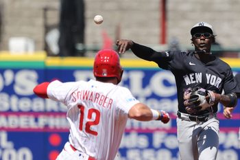 Mar 19, 2025; Clearwater, Florida, USA;  New York Yankees third base Jazz Chisholm Jr. (13) forces out Philadelphia Phillies designated hitter Kyle Schwarber (12) and throws the ball to first base for a double play during the third inning at BayCare Ballpark. Mandatory Credit: Kim Klement Neitzel-Imagn Images