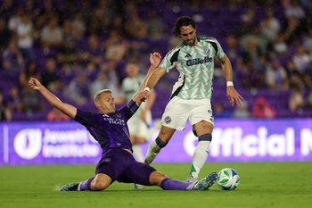 May 10, 2025; Orlando, Florida, USA; Orlando City defender Robin Jansson (6) tackles the ball past New England Revolution forward Leonardo Campana (9) in the first half  at Inter&Co Stadium. Mandatory Credit: Nathan Ray Seebeck-Imagn Images