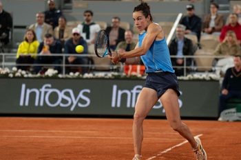 Jun 5, 2025; Paris, FR;  Lois Boisson of France returns a shot during her match against Coco Gauff of the United States on day 12 at Roland Garros Stadium. Mandatory Credit: Susan Mullane-Imagn Images