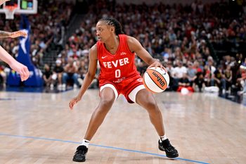 Jun 27, 2025; Dallas, Texas, USA; Indiana Fever guard Kelsey Mitchell (0) brings the ball up court against the Dallas Wings during the second half at the American Airlines Center. Mandatory Credit: Jerome Miron-Imagn Images