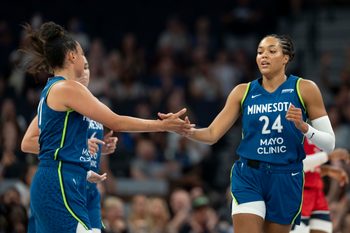 Jul 3, 2025; Minneapolis, Minnesota, USA; Minnesota Lynx forward Napheesa Collier (24) shakes hands with Minnesota Lynx guard Kayla McBride (21) after making a shot against the Washington Mystics in the first half at Target Center. Mandatory Credit: Jesse Johnson-Imagn Images