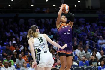 Jul 3, 2025; Arlington, Texas, USA;  Phoenix Mercury forward Satou Sabally (0) shoots over Dallas Wings center Luisa Geiselsoder (18) during the second half at College Park Center. Mandatory Credit: Kevin Jairaj-Imagn Images