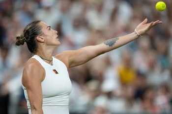 Jul 4, 2025; Wimbledon, United Kingdom; Aryna Sabalenka tosses the ball to serve during her match against Emma Raducanu of Great Britain on day five at the All England Lawn Tennis and Croquet Club. Mandatory Credit: Susan Mullane-Imagn Images