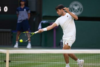 Jul 4, 2025; Wimbledon, United Kingdom;  Carlos Alcaraz of Spain returns a shot during his match against Jan-Lennard Struff of Germany on day five at the All England Lawn Tennis and Croquet Club. Mandatory Credit: Susan Mullane-Imagn Images