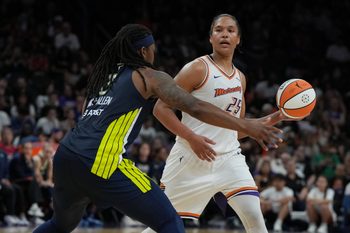 Jul 7, 2025; Phoenix, Arizona, USA; Phoenix Mercury forward Alyssa Thomas (25) looks to pass around Dallas Wings forward Myisha Hines-Allen (2) in the second half at Footprint Center. Mandatory Credit: Rick Scuteri-Imagn Images