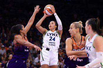 Jul 9, 2025; Phoenix, Arizona, USA; Minnesota Lynx forward Napheesa Collier (24) shoots the ball against Phoenix Mercury forward Alyssa Thomas (25)during the second half at PHX Arena. Mandatory Credit: Mark J. Rebilas-Imagn Images
