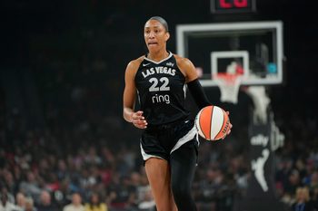 Jul 12, 2025; Las Vegas, Nevada, USA; Las Vegas Aces center A'ja Wilson (22) dribbles the ball against the Golden State Valkyries during the first half of a WNBA basketball game at Michelob Ultra Arena. Mandatory Credit: Lucas Peltier-Imagn Images