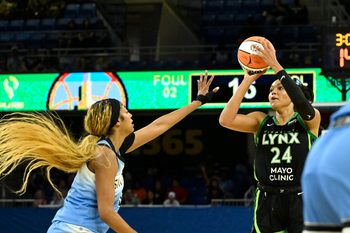 Jul 14, 2025; Chicago, Illinois, USA;  Minnesota Lynx forward Napheesa Collier (24) passes the ball against Chicago Sky forward Angel Reese (5)  during the first half at Wintrust Arena. Mandatory Credit: Matt Marton-Imagn Images