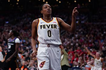 Jul 15, 2025; Boston, Massachusetts, USA; Indiana Fever guard Kelsey Mitchell (0) reacts after her basket and being fouled by the Connecticut Sun in the first quarter at TD Garden. Mandatory Credit: David Butler II-Imagn Images