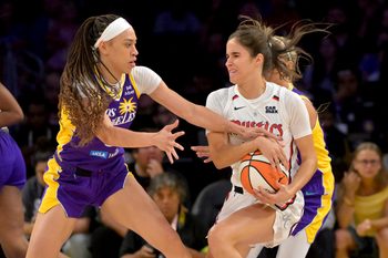 Jul 15, 2025; Los Angeles, California, USA; Los Angeles Los Angeles Sparks forward Dearica Hamby (5) reaches in for the ball controlled by Washington Mystics forward Emily Engstler (21) during the first half at Crypto.com Arena. Mandatory Credit: Jayne Kamin-Oncea-Imagn Images