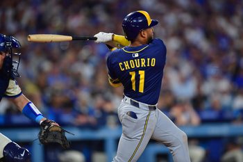 Jul 19, 2025; Los Angeles, California, USA; Milwaukee Brewers right fielder Jackson Chourio (11) hits a single against the Los Angeles Dodgers during the seventh inning at Dodger Stadium. Mandatory Credit: Gary A. Vasquez-Imagn Images