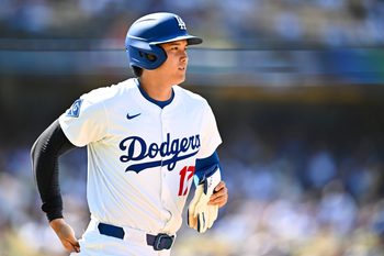 Jul 20, 2025; Los Angeles, California, USA; Los Angeles Dodgers designated hitter Shohei Ohtani (17) heads to first base after a walk against the Milwaukee Brewers during the eighth inning at Dodger Stadium. Mandatory Credit: Jonathan Hui-Imagn Images