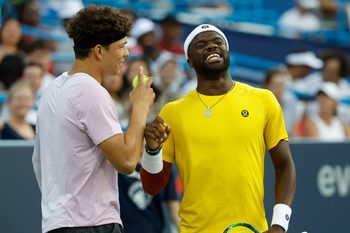 Jul 21, 2025; Washington, D.C., USA; Ben Shelton (USA)(L), jokes with partner Frances Tiafoe (USA)(R) between points against Matthew Ebden and John Peers (both of AUS)(both not pictured) in a men's doubles match on day one of the Mubadala Citi DC Open at Rock Creek Park Tennis Center. Mandatory Credit: Geoff Burke-Imagn Images