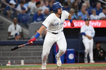 Jul 22, 2025; Toronto, Ontario, CAN;   Toronto Blue Jays right fielder Addison Barger (47) hits an RBI single against the New York Yankees in the fifth inning at Rogers Centre. Mandatory Credit: Dan Hamilton-Imagn Images