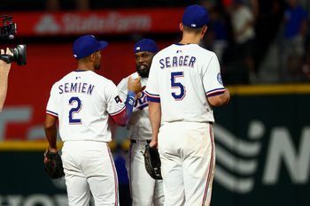 Jul 22, 2025; Arlington, Texas, USA;  Texas Rangers shortstop Corey Seager (5) celebrates with Texas Rangers second baseman Marcus Semien (2) and Texas Rangers right fielder Adolis Garcia (53) after the game against the Athletics at Globe Life Field. Mandatory Credit: Kevin Jairaj-Imagn Images