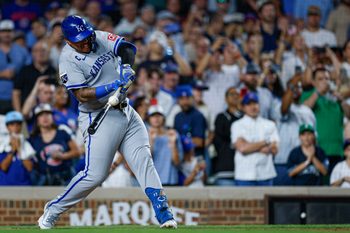 Jul 22, 2025; Chicago, Illinois, USA; Kansas City Royals first baseman Salvador Perez (13) singles against the Chicago Cubs during the ninth inning at Wrigley Field. Mandatory Credit: Kamil Krzaczynski-Imagn Images