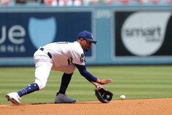 Jul 23, 2025; Los Angeles, California, USA; Los Angeles Dodgers shortstop Mookie Betts (50) fields a ground ball during the second inning against the Minnesota Twins at Dodger Stadium. Mandatory Credit: Kiyoshi Mio-Imagn Images