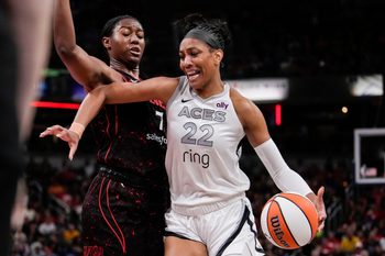 Las Vegas Aces center A'ja Wilson (22) rushes up the court against Indiana Fever forward Aliyah Boston (7) on Thursday, July 24, 2025, during the game at Gainbridge Fieldhouse in Indianapolis.
