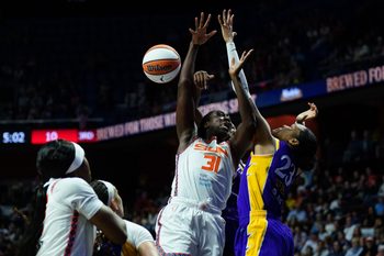 Jul 24, 2025; Uncasville, Connecticut, USA; Los Angeles Sparks forward Azura Stevens (23) defends against Connecticut Sun center Tina Charles (31) in the second half at Mohegan Sun Arena. Mandatory Credit: David Butler II-Imagn Images