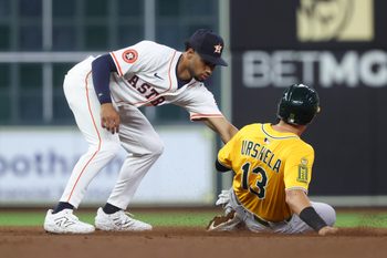 Jul 24, 2025; Houston, Texas, USA;  Athletics third baseman Gio Urshela (13) is out on a stolen base attempt as Houston Astros second baseman Brice Matthews (28) applies a tag during the eighth inning at Daikin Park. Mandatory Credit: Troy Taormina-Imagn Images