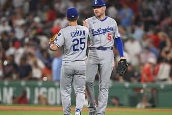 Jul 25, 2025; Boston, Massachusetts, USA; Los Angeles Dodgers first baseman Freddie Freeman (5) high-fives second baseman Tommy Edman (25) after a game against the Boston Red Sox at Fenway Park. Mandatory Credit: Brian Fluharty-Imagn Images