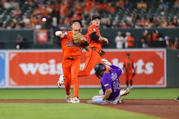 Jul 26, 2025; Baltimore, Maryland, USA; Baltimore Orioles’ second Baseman Jackson Holliday (7) turns a double play against the Colorado Rockies in the seventh inning  at Oriole Park at Camden Yards. Mandatory Credit: Lexi Thompson-Imagn Images