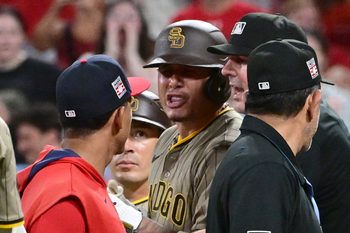 Jul 26, 2025; St. Louis, Missouri, USA; San Diego Padres third baseman Manny Machado (13, right) exchanges words with St. Louis Cardinals coach Jon Jay (19) which lead to players from both teams cleared the dugouts in the ninth inning at Busch Stadium. Mandatory Credit: Tim Vizer-Imagn Images