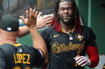 Jul 27, 2025; Pittsburgh, Pennsylvania, USA;  Pittsburgh Pirates center fielder Oneil Cruz (15) celebrates in the dugout after scoring a run against the Arizona Diamondbacks during the second inning at PNC Park. Mandatory Credit: Charles LeClaire-Imagn Images