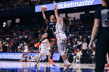 Jul 27, 2025; Washington, District of Columbia, USA; Phoenix Mercury forward Satou Sabally (0) shoots the ball while Washington Mystics center Stefanie Dolson (31) defends in the third quarter at CareFirst Arena. Mandatory Credit: Emily Faith Morgan-Imagn Images