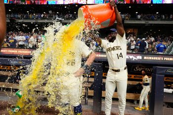 Jul 29, 2025; Milwaukee, Wisconsin, USA; Milwaukee Brewers shortstop Andruw Monasterio (14) dumps Gatorade over Milwaukee Brewers first base Andrew Vaughn (28) head after the game in which Milwaukee  Andrew Vaughn (28) hit a grand slam against the Chicago Cubs at American Family Field. Mandatory Credit: Michael McLoone-Imagn Images