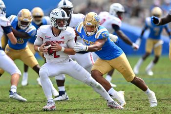 Sep 17, 2022; Pasadena, California, USA;  South Alabama Jaguars quarterback Carter Bradley (2) escapes a sack by UCLA Bruins linebacker Darius Muasau (53) in the second half against the UCLA Bruins at the Rose Bowl. Mandatory Credit: Jayne Kamin-Oncea-Imagn Images