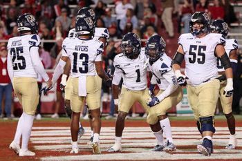 Nov 18, 2023; Fayetteville, Arkansas, USA; FIU Panthers quarterback Keyone Jenkins (1) celebrates after scoring a touchdown in the first quarter against the Arkansas Razorbacks at Donald W. Reynolds Razorback Stadium. Mandatory Credit: Nelson Chenault-Imagn Images