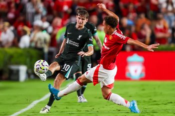 Aug 3, 2024; Columbia, South Carolina, USA; Liverpool midfielder Tyler Morton (80) kicks the ball past Manchester United defender Sam Murray (61) in the second half at Williams-Brice Stadium. Mandatory Credit: Jeff Blake-Imagn Images