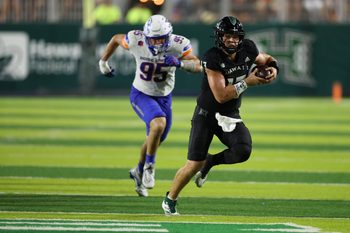 Oct 12, 2024; Honolulu, Hawaii, USA;  Hawaii Rainbow Warriors quarterback Brayden Schager (13) gets chased down by Boise State Broncos defensive end Max Stege (95) during the fourth quarter of a NCAA college football game at Clarence T.C. Ching Athletics Complex. Mandatory Credit: Marco Garcia-Imagn Images