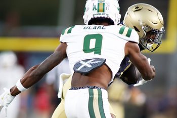 Oct 19, 2024; Annapolis, Maryland, USA; Navy Midshipmen cornerback Dashaun Peele (1) makes an interception over Charlotte 49ers wide receiver O'Mega Blake (9) during the second half at Navy-Marine Corps Memorial Stadium. Mandatory Credit: Daniel Kucin Jr.-Imagn Images