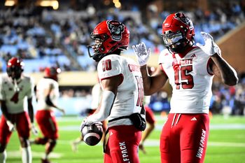 Nov 30, 2024; Chapel Hill, North Carolina, USA; North Carolina State Wolfpack wide receiver Kevin Concepcion (10) celebrates with North Carolina State Wolfpack tight end Justin Joly (15) after scoring a touchdown in the fourth quarter at Kenan Memorial Stadium. Mandatory Credit: Bob Donnan-Imagn Images