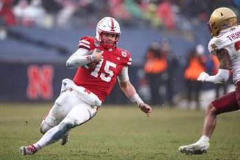 Dec 28, 2024; Bronx, NY, USA; Nebraska Cornhuskers quarterback Dylan Raiola (15) slides during the second half against the Boston College Eagles at Yankee Stadium. Mandatory Credit: Vincent Carchietta-Imagn Images
