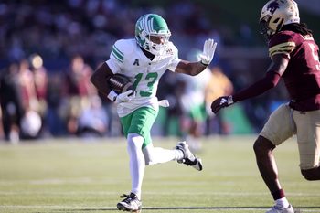 Jan 3, 2025; Dallas, TX, USA; North Texas Mean Green wide receiver Miles Coleman (13) runs for a touchdown against Texas State Bobcats safety Darius Jackson (5) during the first quarter at Gerald J. Ford Stadium. Mandatory Credit: Tim Heitman-Imagn Images