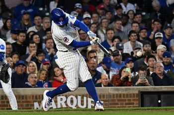 Apr 23, 2025; Chicago, Illinois, USA;  Chicago Cubs shortstop Dansby Swanson (7) hits a two RBI single against the Los Angeles Dodgers during the fifth inning at Wrigley Field. Mandatory Credit: Matt Marton-Imagn Images