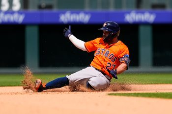 Jul 3, 2025; Denver, Colorado, USA; Houston Astros designated hitter Jose Altuve (27) slides for a double in the seventh inning against the Colorado Rockies  at Coors Field. Mandatory Credit: Ron Chenoy-Imagn Images
