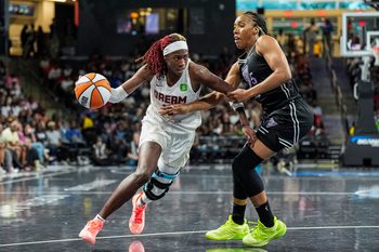 Jul 7, 2025; College Park, Georgia, USA; Atlanta Dream guard Rhyne Howard (10) dribbles against Golden State Valkyries forward Kayla Thornton (5) during the second half at Gateway Center Arena at College Park. Mandatory Credit: Dale Zanine-Imagn Images