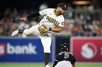 Jul 10, 2025; San Diego, California, USA; San Diego Padres shortstop Xander Bogaerts (2) jumps for a high throw as Arizona Diamondbacks shortstop Blaze Alexander (9) steals second base during the eighth inning at Petco Park. Mandatory Credit: Denis Poroy-Imagn Images