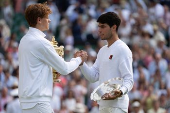 Jul 13, 2025; Wimbledon, United Kingdom; Carlos Alcaraz of Spain and Jannik Sinner of Italy pose with their trophies after the men’s singles final on day 14 at All England Lawn Tennis and Croquet Club. Mandatory Credit: Susan Mullane-Imagn Images