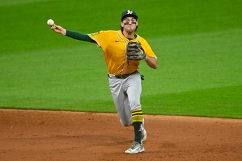 Jul 19, 2025; Cleveland, Ohio, USA; Athletics shortstop Jacob Wilson (5) throws to first base in the sixth inning against the Cleveland Guardians at Progressive Field. Mandatory Credit: David Richard-Imagn Images